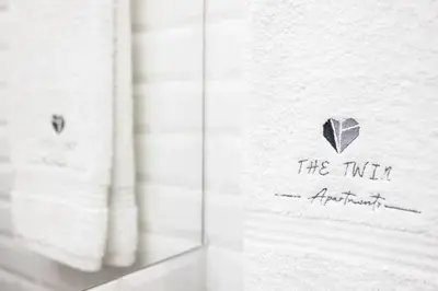 a towel with a heart on it on a shelf at THE TWIN Apartments in Porto