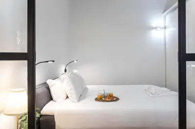 a room with a bed with a plate of food on it at Elegant & Bright Flat by LovelyStay in Porto