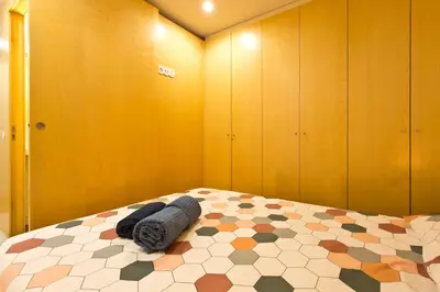 a bedroom with a bed with towels on it at Oporto Blue República - Cozy City Centre Studio in Porto