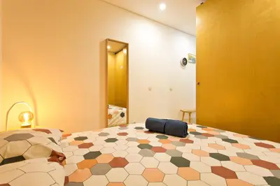 a bedroom with a large bed with a blue pillow on it at Oporto Blue República - Cozy City Centre Studio in Porto