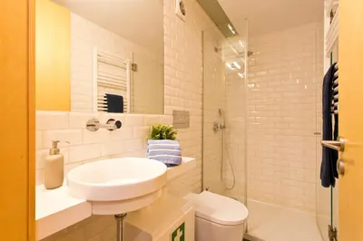 a bathroom with a sink and a toilet and a shower at Oporto Blue República - Cozy City Centre Studio in Porto