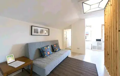 a living room with a couch and a table at Oporto Blue Liberdade - Central Studio with Amazing View and Kitchenette in Porto