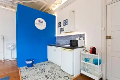 a kitchen with a blue wall in a room at Oporto Blue Aliados - Historic City Center Studio in Porto