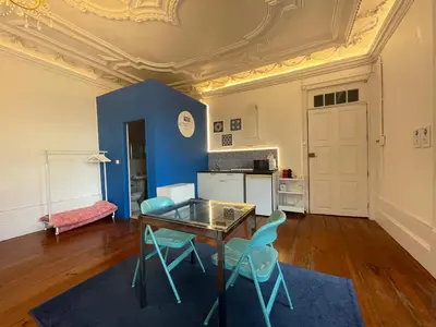 a kitchen with a table and chairs in a room at Oporto Blue Aliados - Historic City Center Studio in Porto