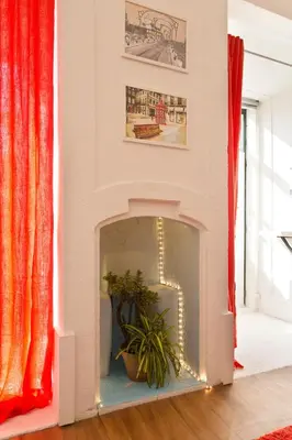 a living room with a fireplace with a plant in it at Oporto Blue Cedofeita - Charming Citycenter Loft in Porto