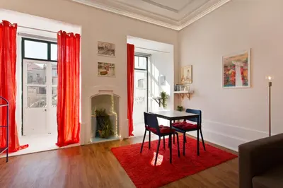 a dining room with red curtains and a table and chairs at Oporto Blue Cedofeita - Charming Citycenter Loft in Porto