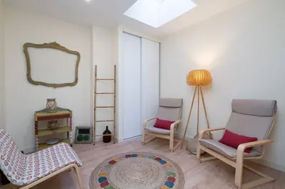 a living room with two chairs and a mirror at Gaya Avenue Flats - Elegant Contemporary Flats with Balcony in Vila Nova de Gaia