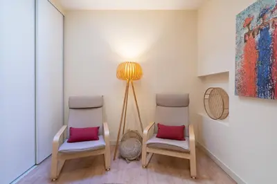 two chairs and a lamp in a room at Gaya Avenue Flats - Elegant Contemporary Flats with Balcony in Vila Nova de Gaia