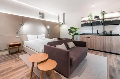 a bedroom with a bed and a couch and a table at GuestReady - Mercadores 150 in Porto
