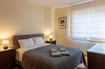 a bedroom with a bed with two towels on it at Preciosa Apartment by MP in Vila Nova de Gaia