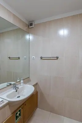 a bathroom with a sink and a mirror at Preciosa Apartment by MP in Vila Nova de Gaia