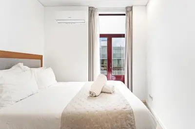 two towels on a bed in a hotel room at Alma Invicta Almada in Porto