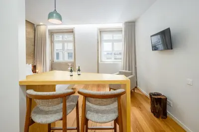a room with a wooden table and some chairs at Porta Nobre Boutique Hotel by Aspasios in Porto