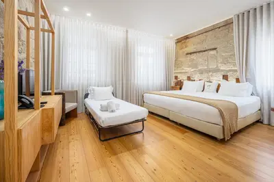 a hotel room with a large bed and a television at Porta Nobre Boutique Hotel by Aspasios in Porto