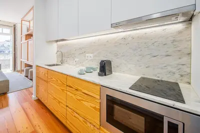 a kitchen with a sink and a stove at Porta Nobre Boutique Hotel by Aspasios in Porto
