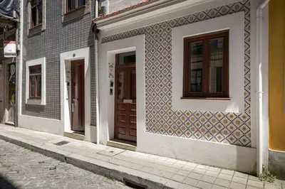 a building with doors on the side of a street at BRA com Apartments Oporto House 68 in Porto