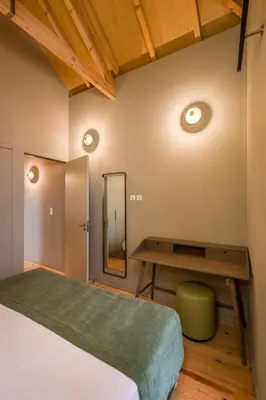 a bedroom with a bed and a desk and a mirror at BRA com Apartments Oporto House 68 in Porto