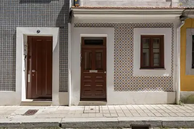 two doors on the side of a building at BRA com Apartments Oporto House 68 in Porto