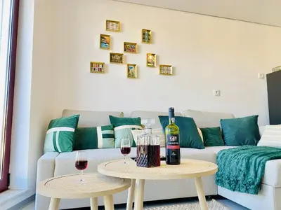 a living room with a couch and two tables with wine glasses at Douro Eiffel Bridge Amazing View in Vila Nova de Gaia