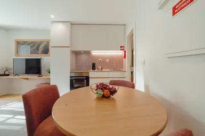 a dining room table with chairs and a bowl of fruit on it at River Eyes at Porto apartments in Porto