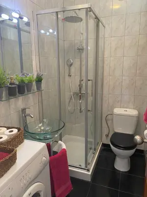 a bathroom with a shower with a toilet and a glass table at Apartamento com patio na rua principal da cidade in Porto
