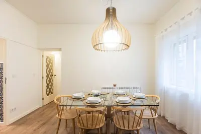 a dining room with a glass table and chairs at Tasteful 2BR Flat in Art District by LovelyStay in Porto