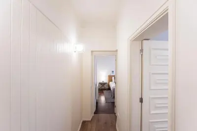 a hallway with a white door leading to a bedroom at Tasteful 2BR Flat in Art District by LovelyStay in Porto