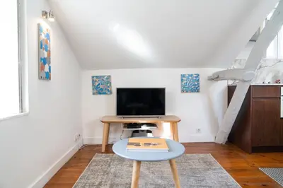 a living room with a tv and a table at Ribeira Loft in Porto