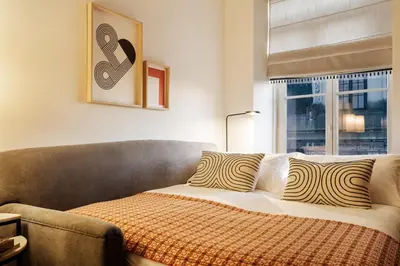 a bedroom with a bed and a window at Liberty 119 • Luxurious 1BD in Porto's main Avenue in Porto