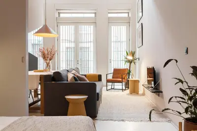 a living room with a couch and a table at VIVA Miragaia Downtown in Porto