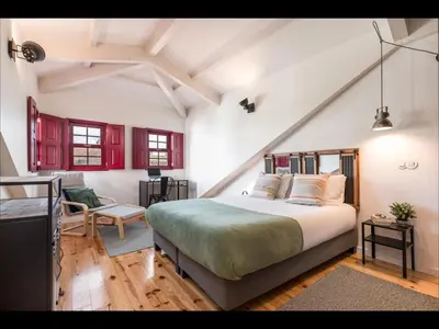 a bedroom with a bed in a room with red cabinets at GET a train and city view in Porto