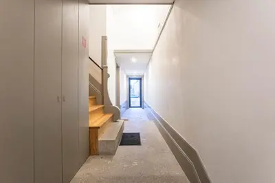 a hallway of a house with stairs and a window at Downtown Studio w/ AC & Patio by LovelyStay in Porto