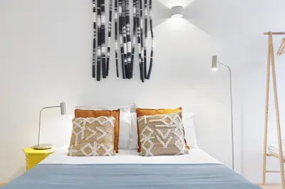 a white dining room with a white table and chairs at InBloom Apartments 2 in Porto
