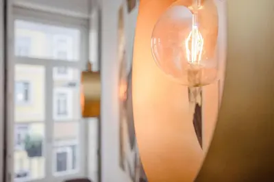 a light hanging on a wall with a mirror at Liiiving in Porto - Ribeira Secret Apartment in Porto