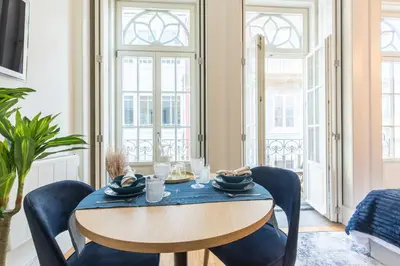 a dining room with a wooden table and chairs at In Between Exclusive Charm Apartment by the center in Porto