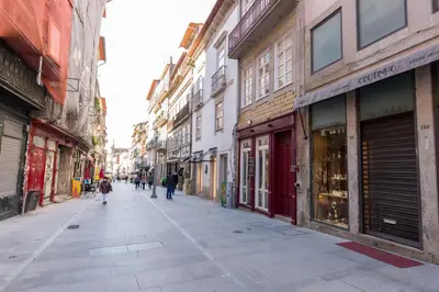 an empty city street with people walking down the street at In Between Exclusive Charm Apartment by the center in Porto