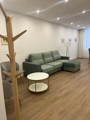 a living room with a green couch and a table at ORM- Flores Apartment in Porto