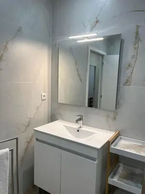 a white bathroom with a sink and a mirror at ORM- Flores Apartment in Porto