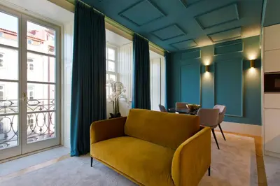 a living room with a yellow couch and a table at BOUTIQUE Rentals-Kinga’s Ribeira River great views in Porto