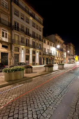 an empty city street at night with buildings at BOUTIQUE Rentals-Kinga’s Ribeira River great views in Porto