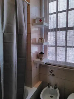 a bathroom with a sink and a toilet and a window at Oportobestview-Douro in Porto