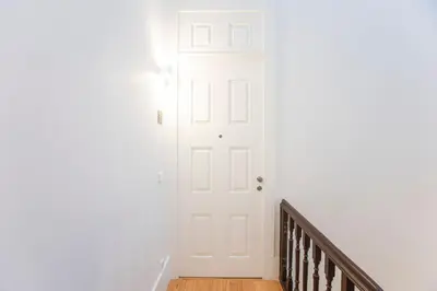 a white door in a room with a staircase at Modern 2BR Duplex Downtown by Art District by LovelyStay in Porto