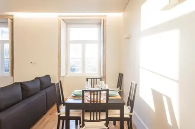 a dining room with a table and a couch at Modern 2BR Duplex Downtown by Art District by LovelyStay in Porto