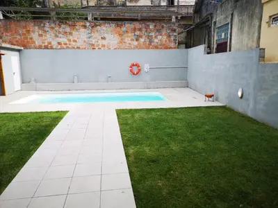 a swimming pool in a yard with grass at OPORTO WINE LOFTS in Vila Nova de Gaia