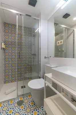a bedroom with a bed with two towels on it at Portucale Guest House- Self check-in in Porto