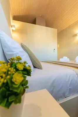 a dining room with a table and two windows at Portucale Guest House- Self check-in in Porto