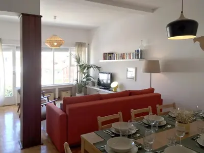 a living room with a red couch and a table at PinPorto City Center III in Porto