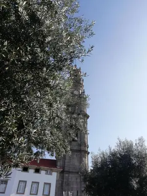 a tower with a clock on it next to a building at Luxury Prime Batalha Apartments in Porto