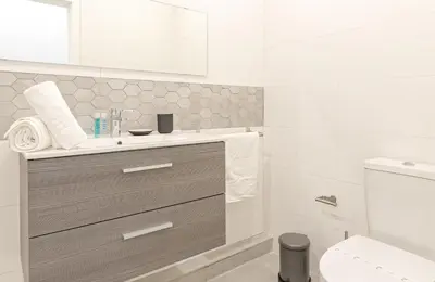 a bathroom with a sink and a toilet at Luxury Prime Batalha Apartments in Porto