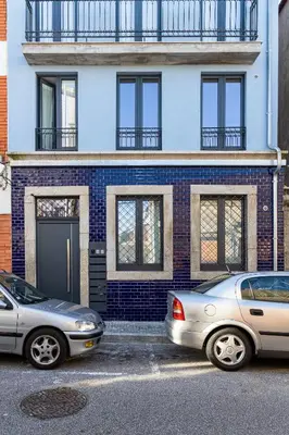 two cars parked in front of a brick building at Alvaro's Charming Loft by MP in Vila Nova de Gaia